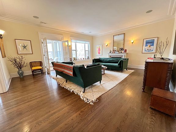 Grand living room. Hardwood floors throughout, high ceilings, French doors.