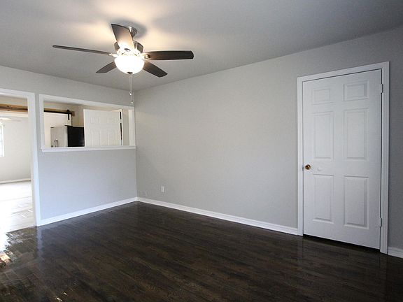 Living room has coat closet by front door and open to the kitchen