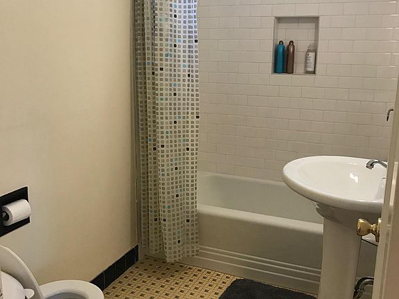 bathroom with shower over bathtub