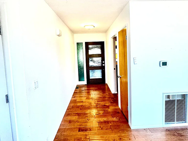 View toward front door from dining room and deck