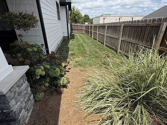 Fenced side yard is a great place to let dogs out! Note that this is the only fenced grassy area on the property. Grass area behind the garage is fenced off and belongs to the apartment above the garage.