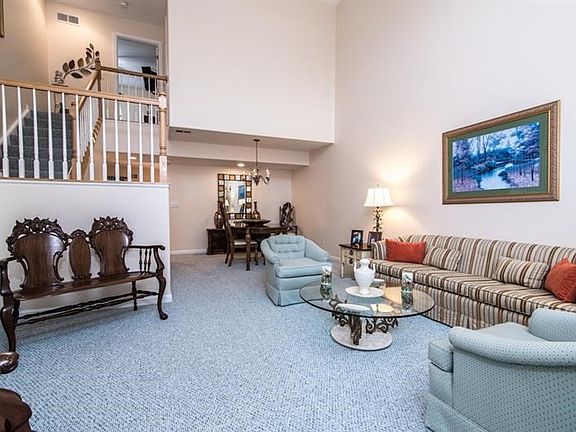 Open concept flows to dining room and stairway.