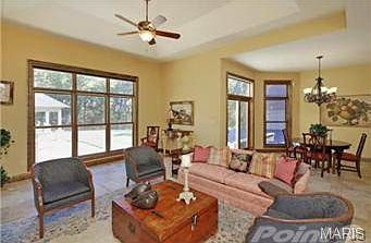 Beyond the hearth room is a view of a fabulous outdoor kitchen a