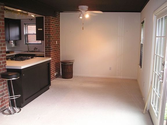 Family Room boasts a brick wall, patio doors, media nook and half bath