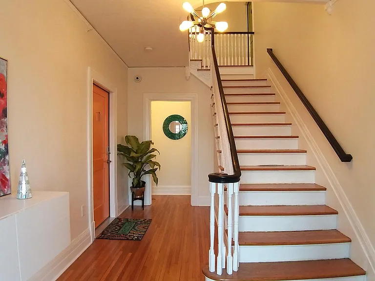 Foyer- Apartment 1 is orange door on the left..