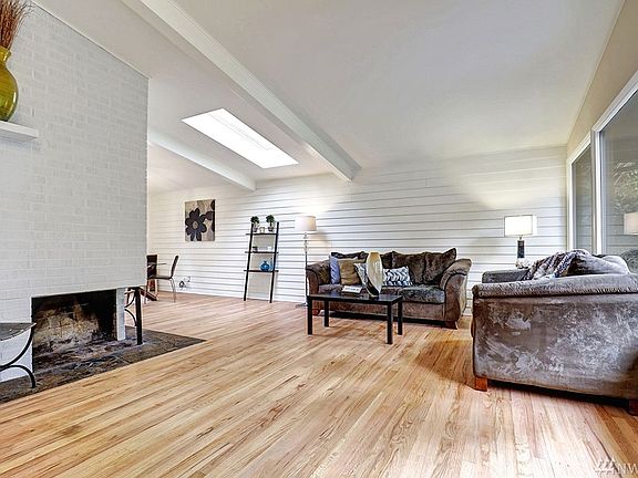 Cozy Formal Living Room with Wood Burning Fireplace and Skylight