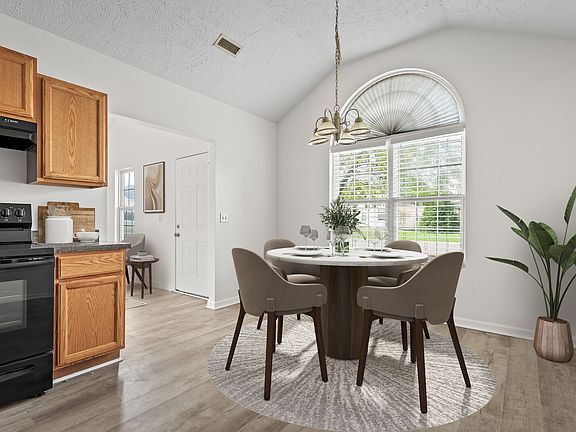 Kitchen is virtually staged and has plenty of room for a larger table. Kitchen has vaulted ceiling and a large window welcoming in plenty of natural light