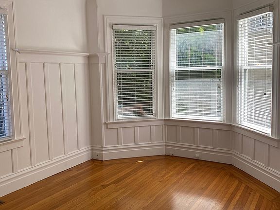 Bedroom 1 with 4 full size windows, a view of downtown & coved ceilings