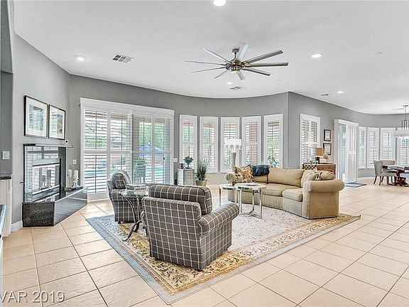 Living room with gas fireplace & tile floor.