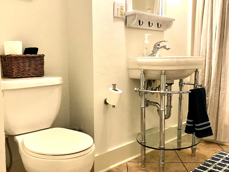 Spacious bathroom with new lighting and fixtures.