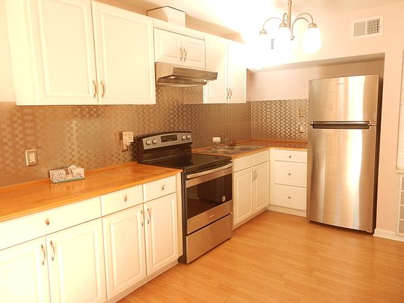 all stainless appliances, and custom countertop with stainless backsplash