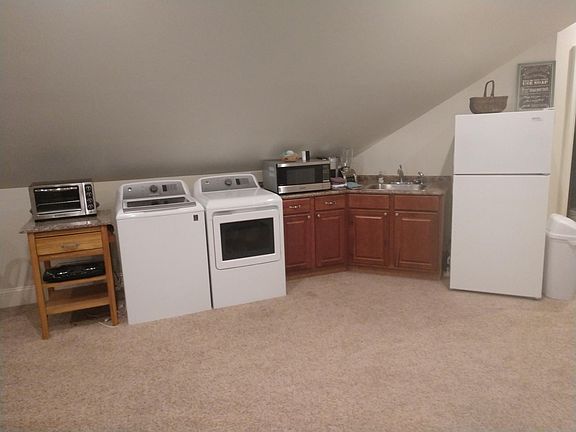 New kitchen area with washer and dryer.