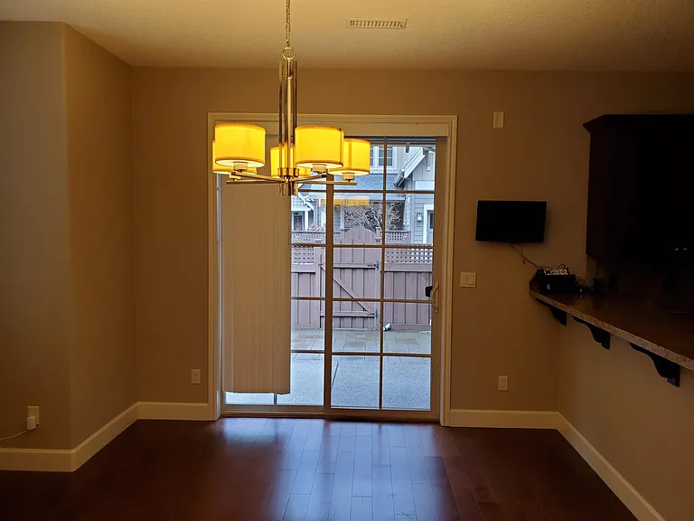 Dining area with hardwood floors .