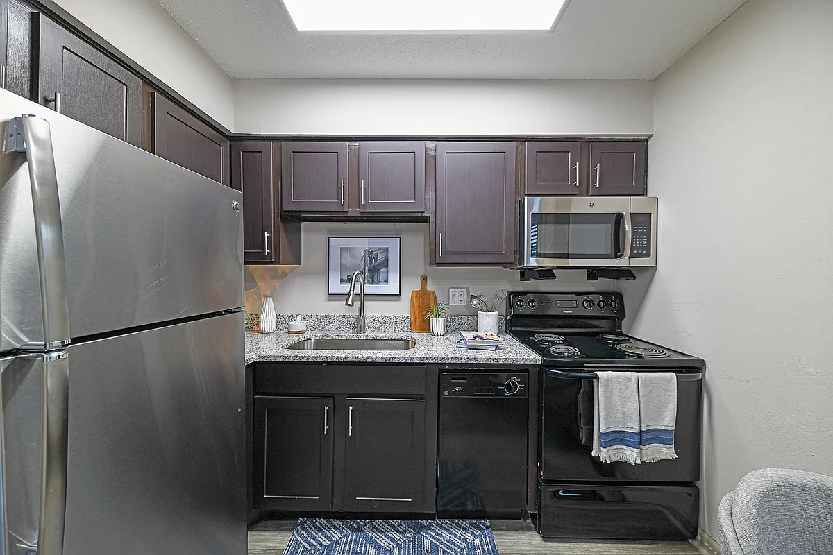 Experience culinary elegance in this modern kitchen, equipped with top-quality appliances and stylish finishes. - Element at Cedar Bluff