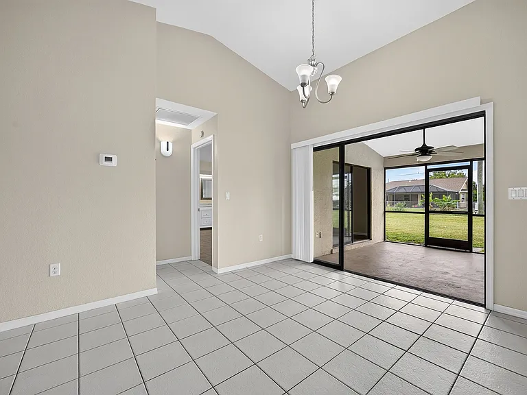Dining area opening to the covered screened lanai