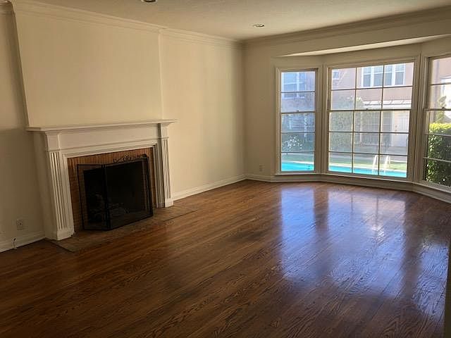 Livingroom with bay window overlooking the courtyard with a swimming pool