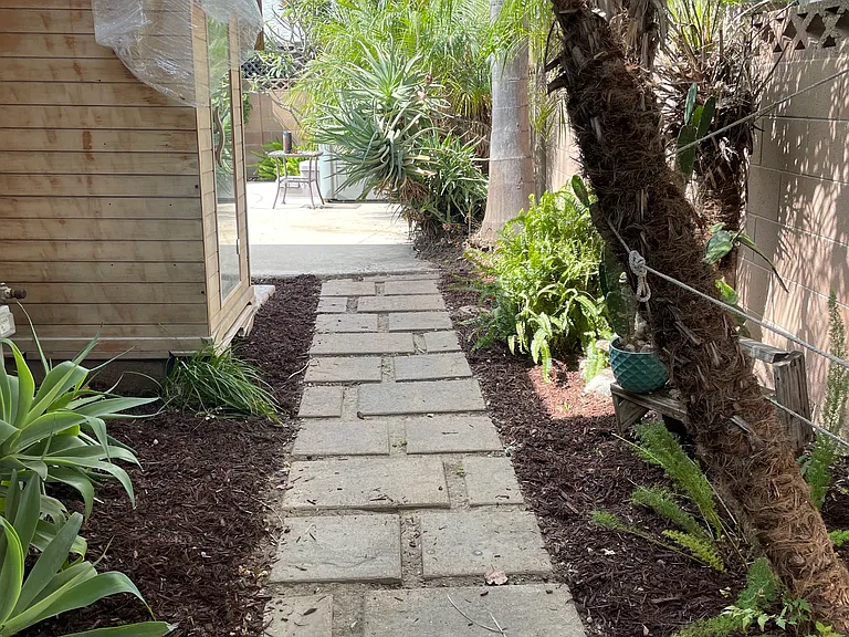 Side walkway to enter backyard and get to and from kitchen/tile entrance. This access also gets out the gate and to garage.