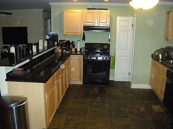 Granite countertops and tile floor.
