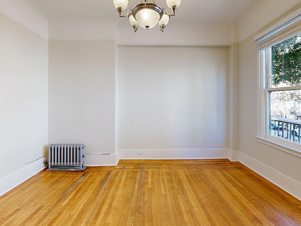 Living room with a window and wood-like flooring