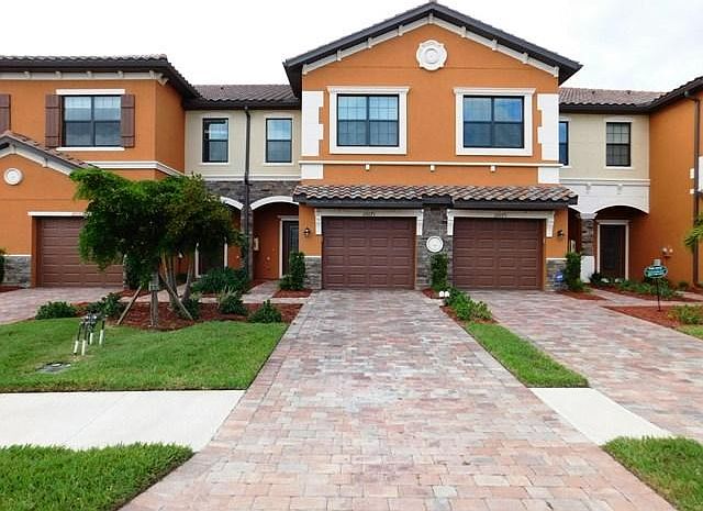 Welcoming Paver Driveway with One-Car Garage
