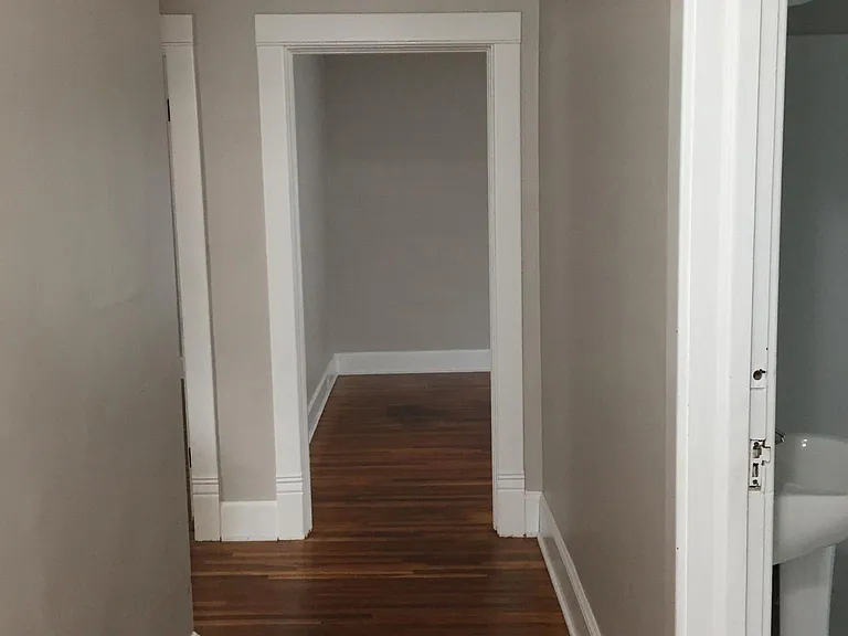 Entry hallway, bathroom on the right, looking at the living room