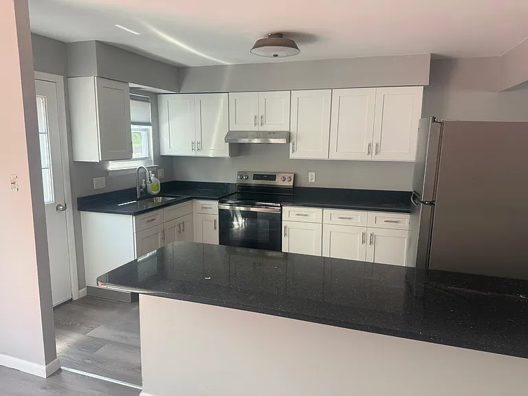 Newly renovated kitchen with appliances and brand new cabinets and countertops