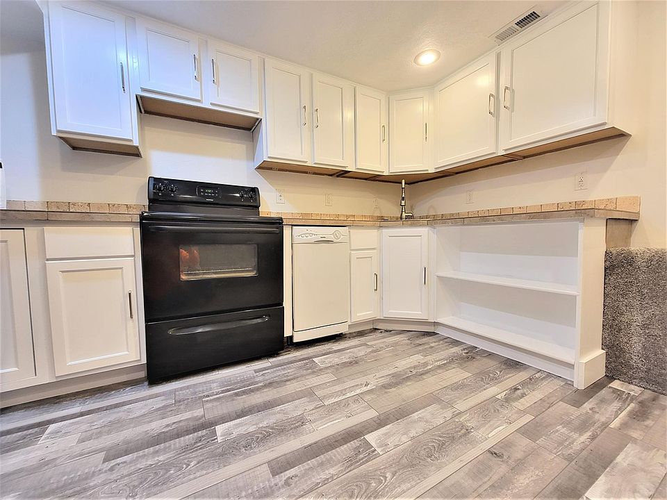 Kitchen has newly refinished cabinet's, new paint, new luxury vinyl flooring, custom tile countertops, and custom overflow shelving. Includes refrigerator, electric stove, dishwasher and microwave.