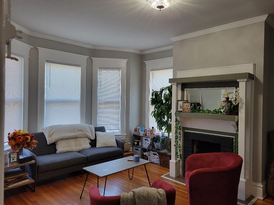 Living room with bay windows and decorative fireplace