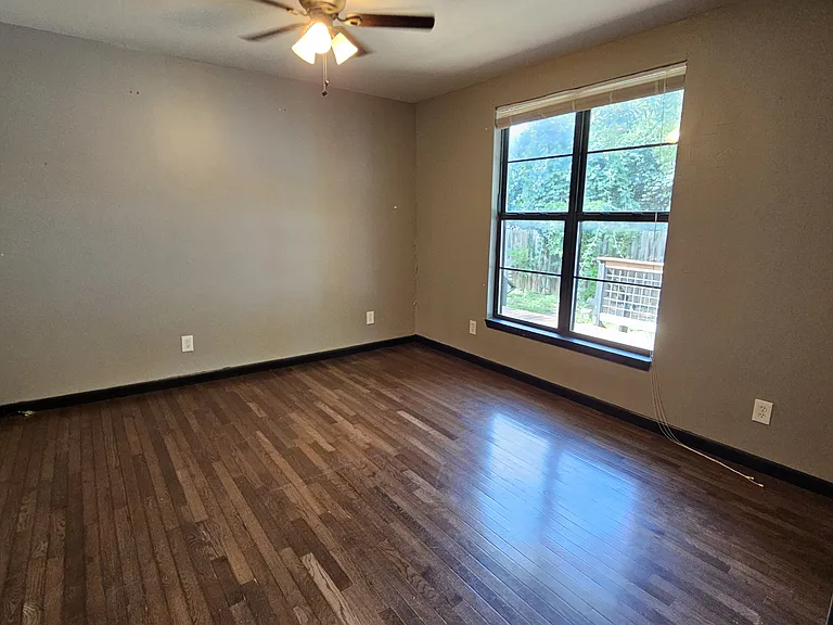 Second bedroom with backyard_facing windows, conveniently located across from the hallway bathroom