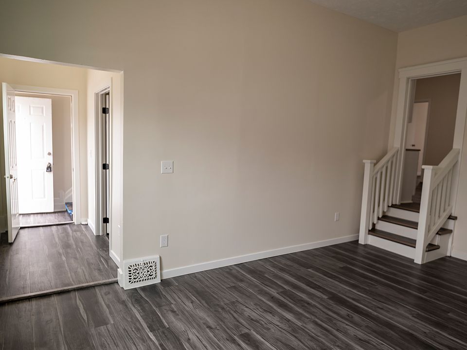 Living area looking back to the front door on the left. Stairs to kitchen are on the right.