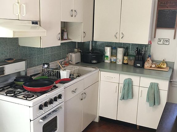 Neutral white cabinets.  *countertop and flooring to be repl