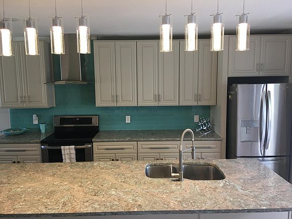 Large 11 foot island with Cambria coastal countertops with stainless steel appliances. Tons of cabinet space. Soft close doors and drawers.