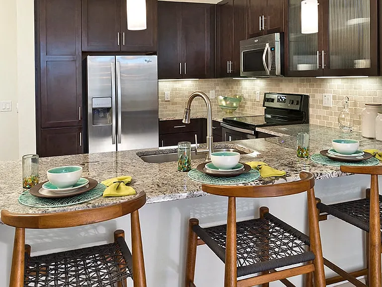 Granite or quartz countertops with designer backsplash