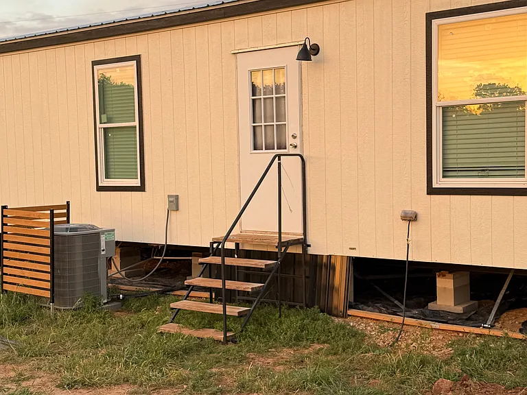 Stairs exit rear of home. Working on landscaping.