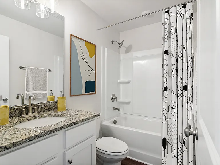 Secondary suite bathroom with a tub and shower combination