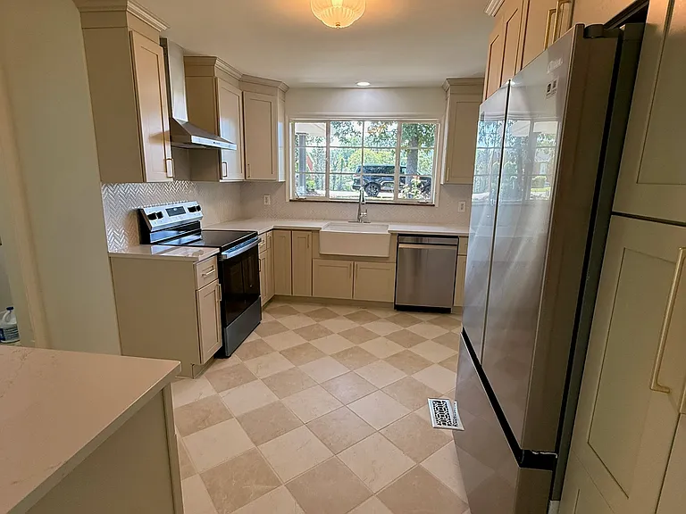 Completely renovated kitchen with new custom cabinets, farmhouse sink, new stainless steel appliances.