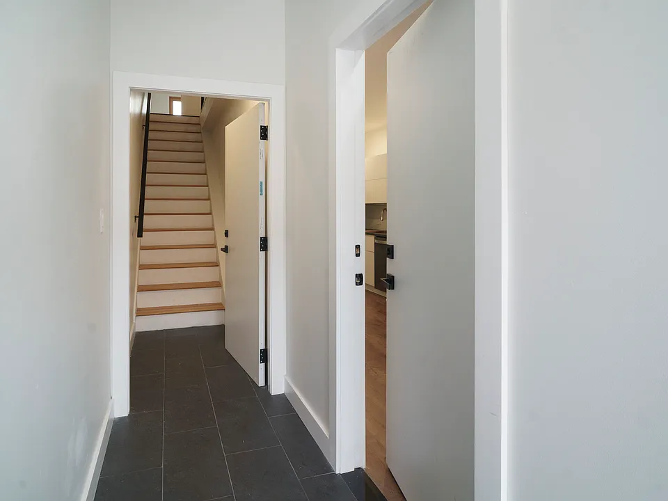 Building entryway - open entry door and stairway up to 2nd floor apartment - 1st floor apartment entry on the right in photo