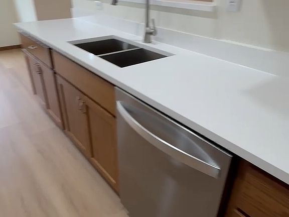 Quartz countertop with stainless steel sink.