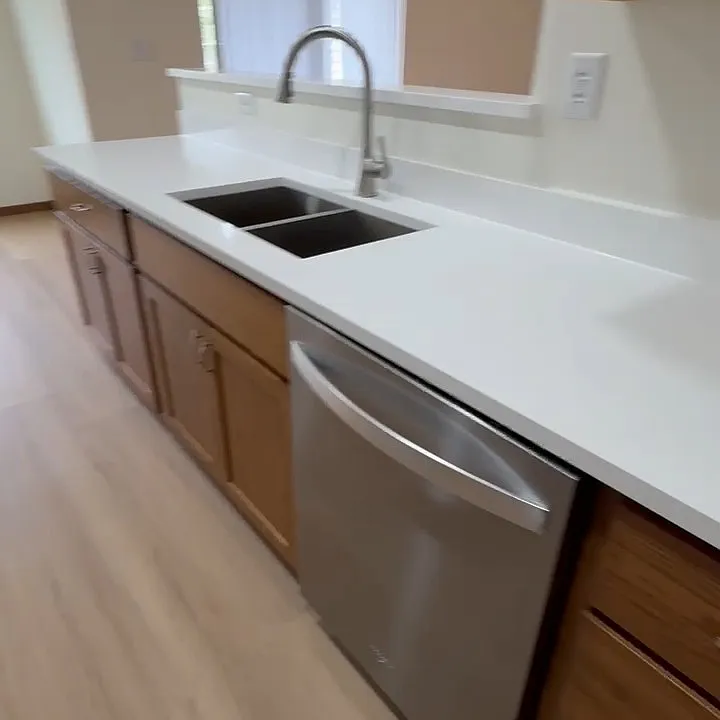 Quartz countertop with stainless steel sink.