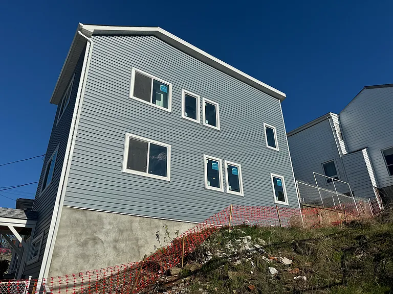 side view of the property with new windows and siding and roof