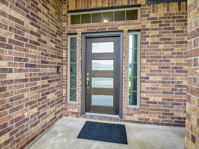 Front door with privacy glass and one-way mirror sidelights.