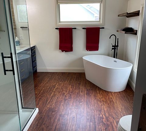 Master bathroom with tub and shower. Extra closet between bedroom and bathroom.