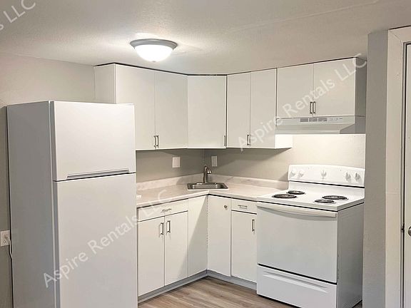 The kitchen is equipped with an electric range and a refrigerator; there is no dishwasher or garbage disposal.