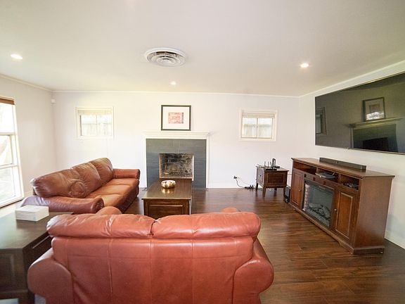 Spacious living room with laminate flooring and fireplace. Some Furniture optional. TV, sound bar, and entertainment center not included.