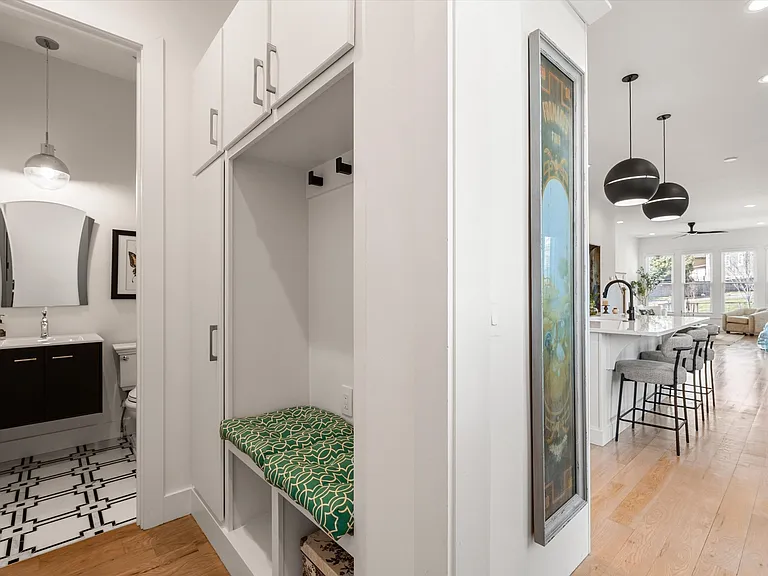 Built-in mudroom with bench seating, coat hooks, and storage cabinets for everyday organization.