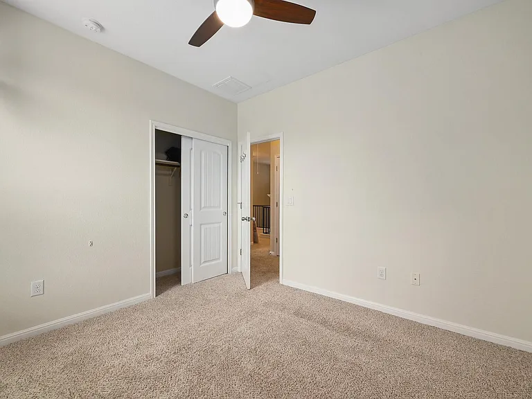 bedroom 2 with view of closet