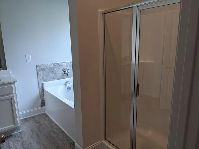 Master bath with shower and garden tub, double sinks, WC, and walk-in closet