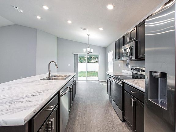 Open kitchen with Counter-height Island - New home for sale in Eagle Lake, FL. Photo showcases a hom
