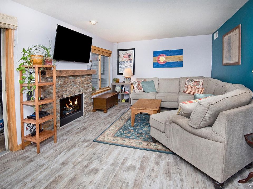 cozy living room with new fireplace insert & surround. New high-end laminate flooring (very wood-like & durable)!
