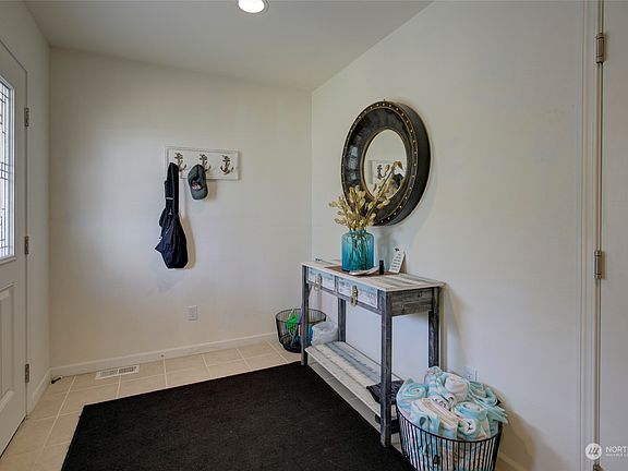 Entry area is spacious and has access to the garage.>
